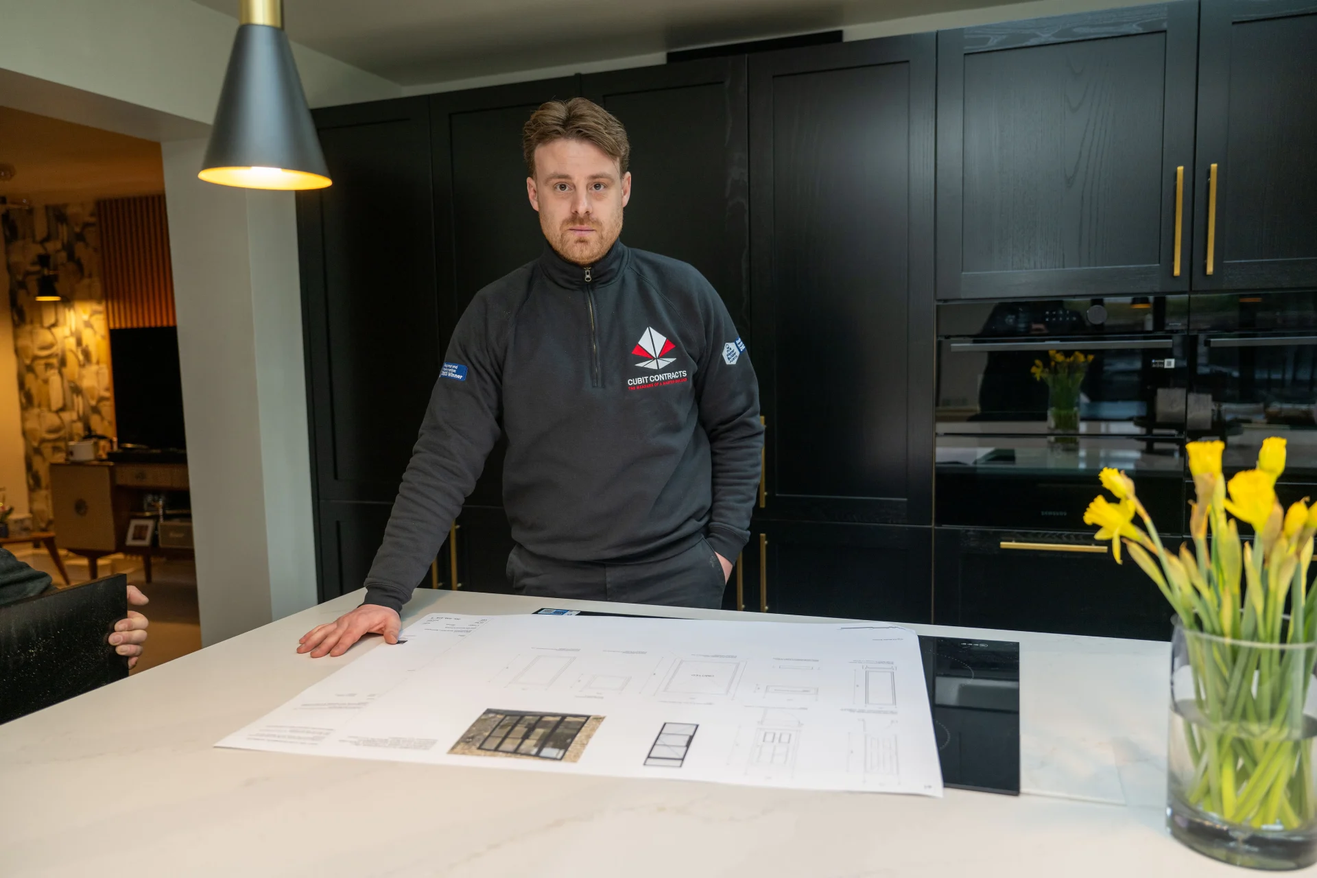 lewis from cubit contracts looking over plans for a new home renovation